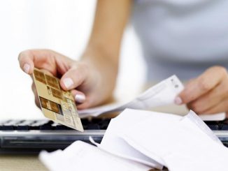 woman reading receipts and holding a credit card