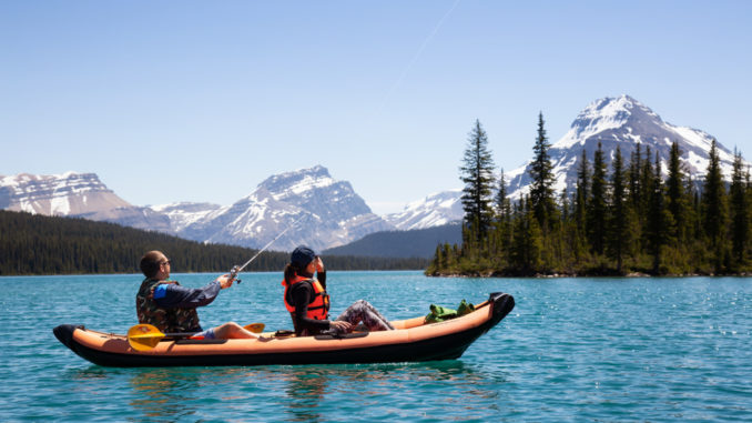 couple fishing from kayak on lake